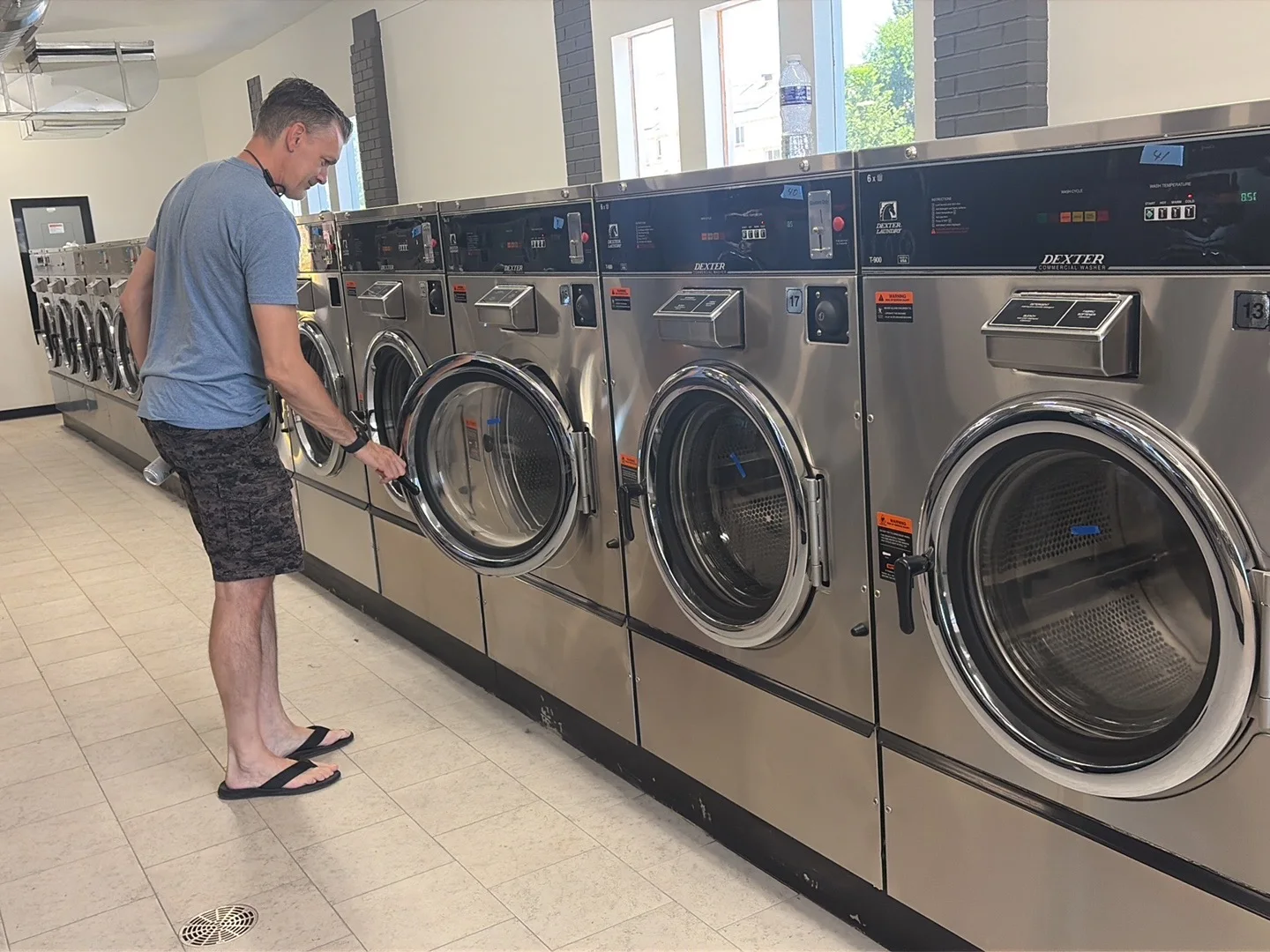 Customer using a new Dexter washer at Wash'em Up Laundry #9