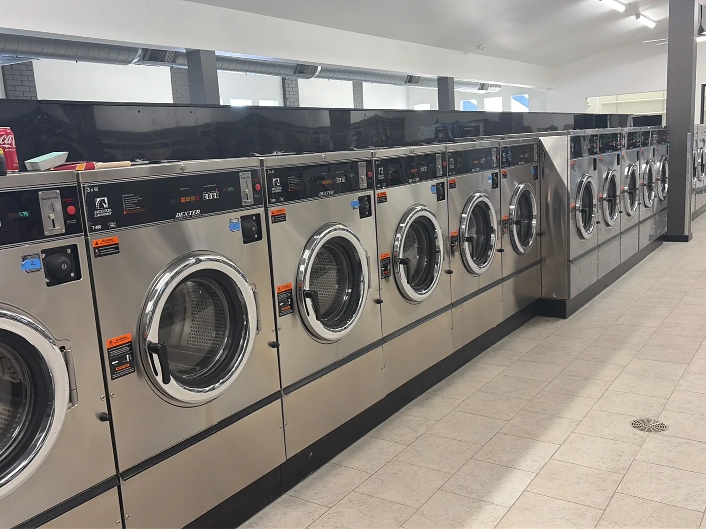 Row of new Dexter washing machines inside the Colfax laundromat