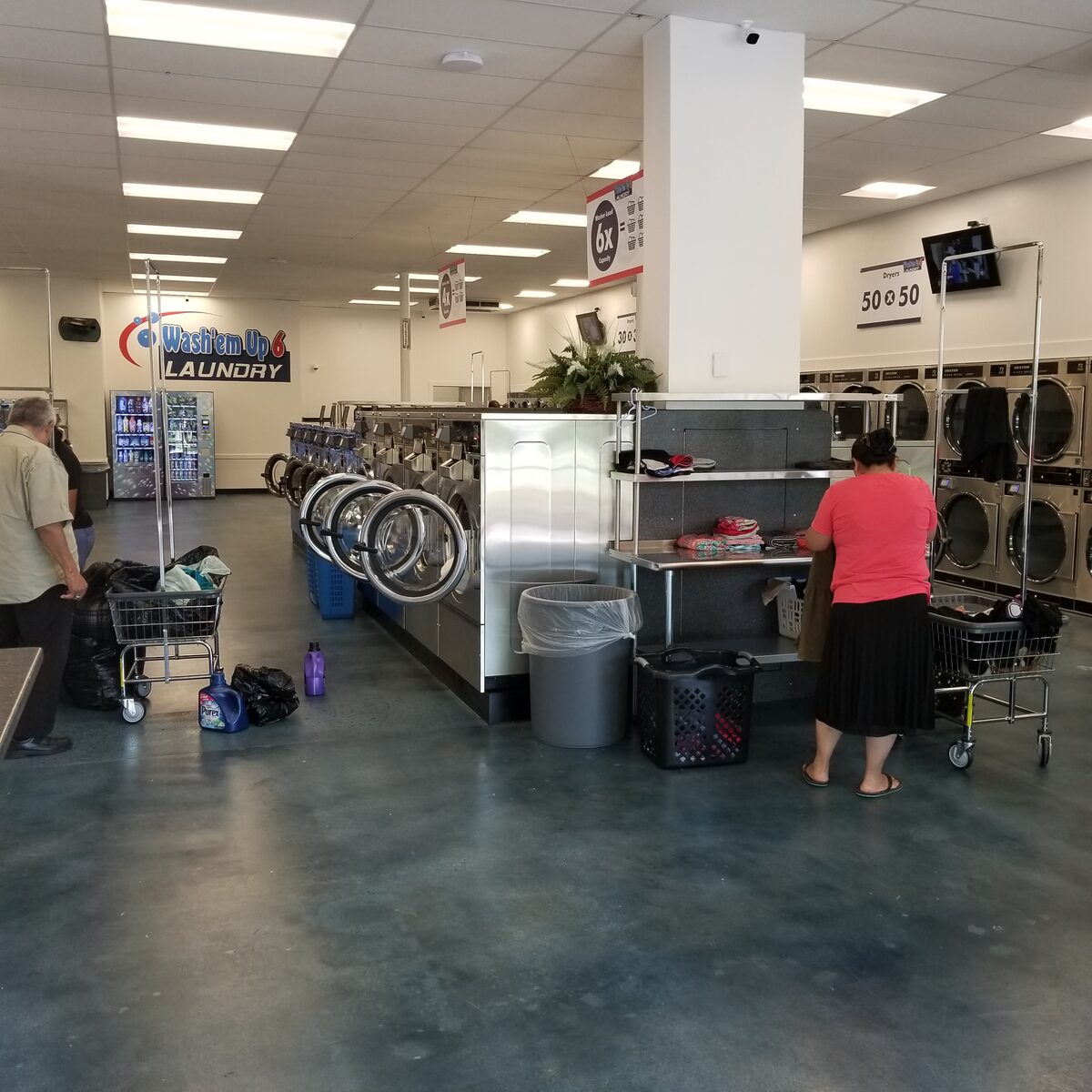 Rows of laundry machines inside Wash'em Up Laundry #6 - Laundromat Aurora